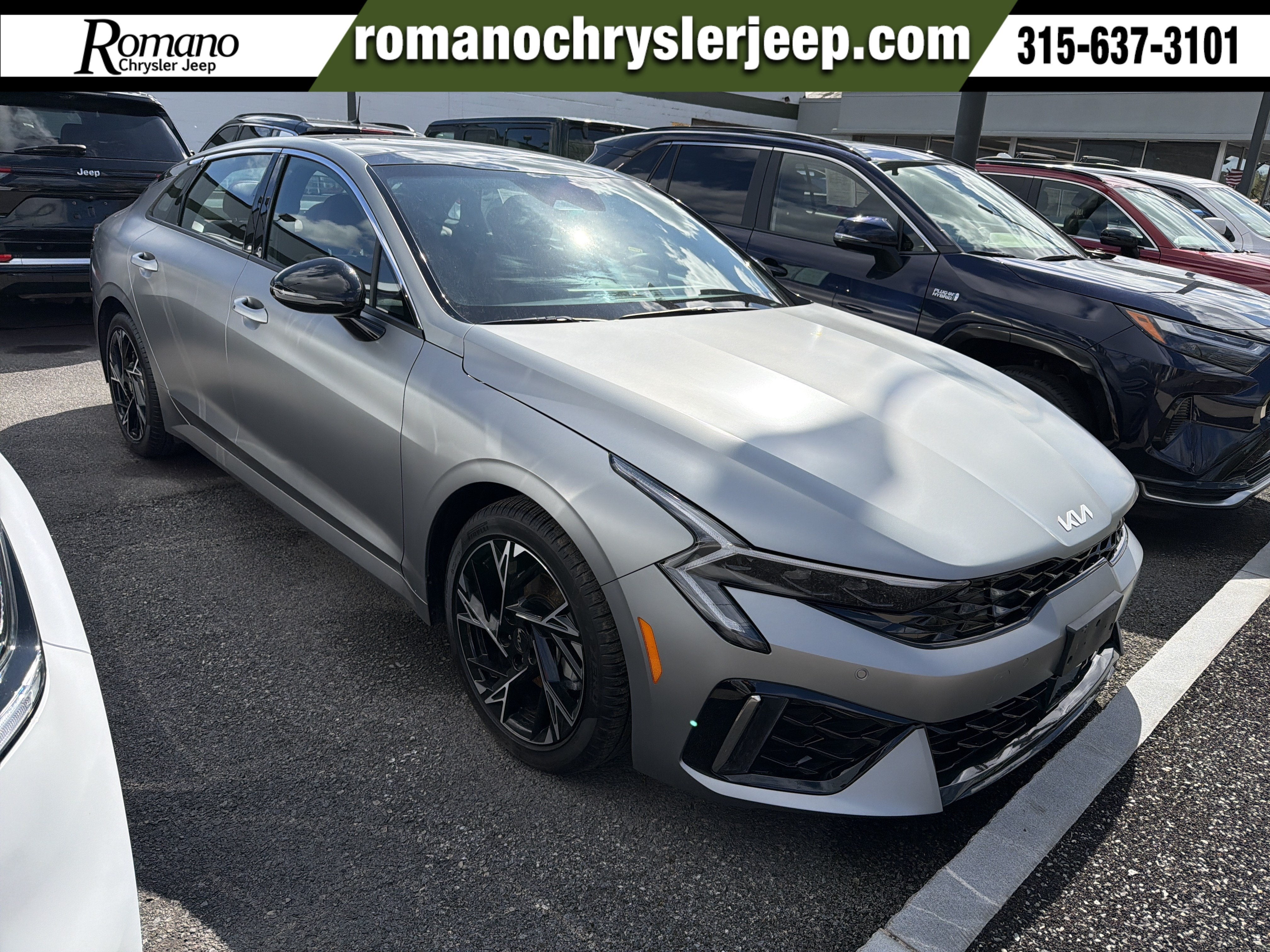 2025 Kia K5 GT-Line in Steel Matte Gray — front three-quarter view